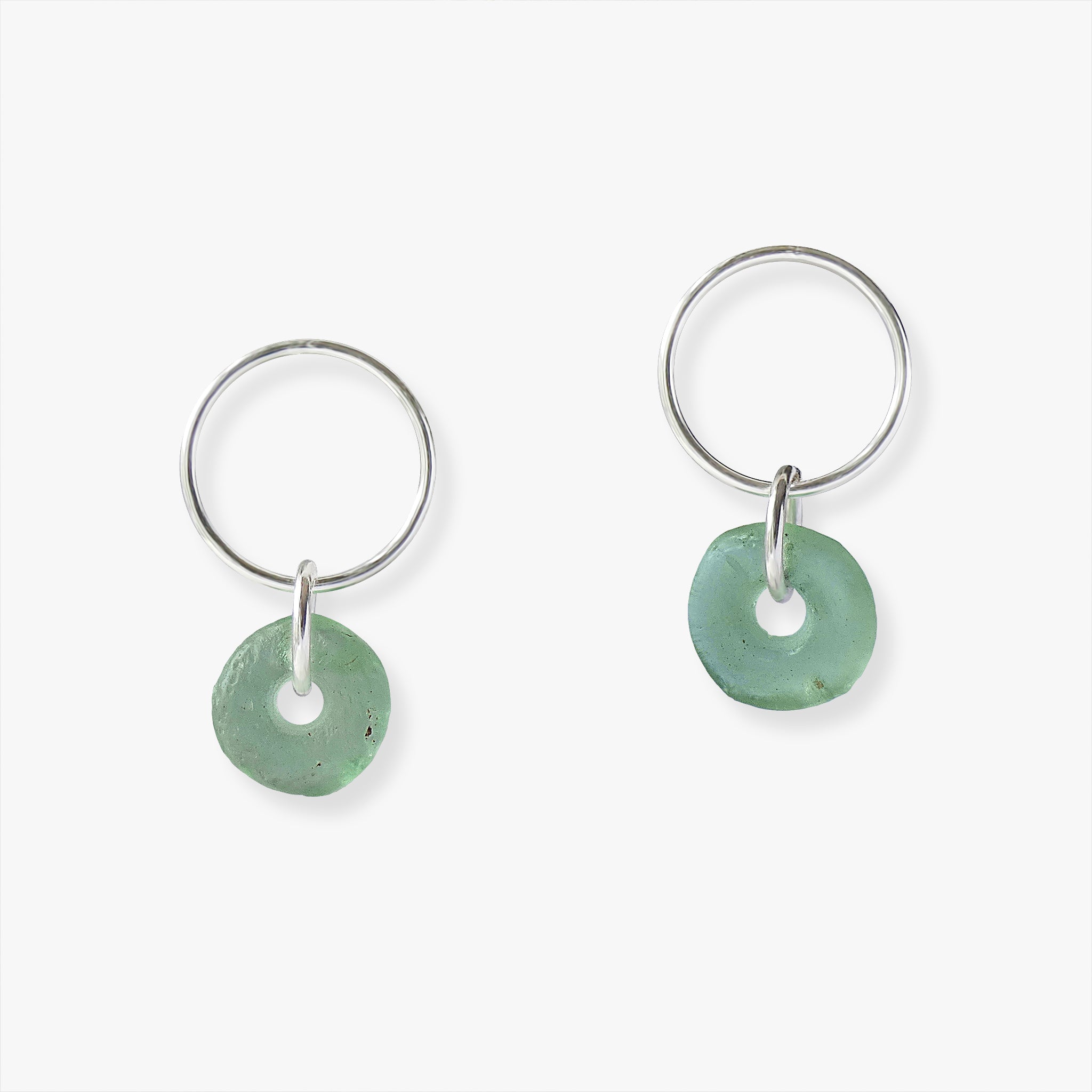 mmi3nsa sterling silver circle stud earrings, with aqua coloured doughnut shaped beads. The beads are handmade in Ghana from recycled glass.